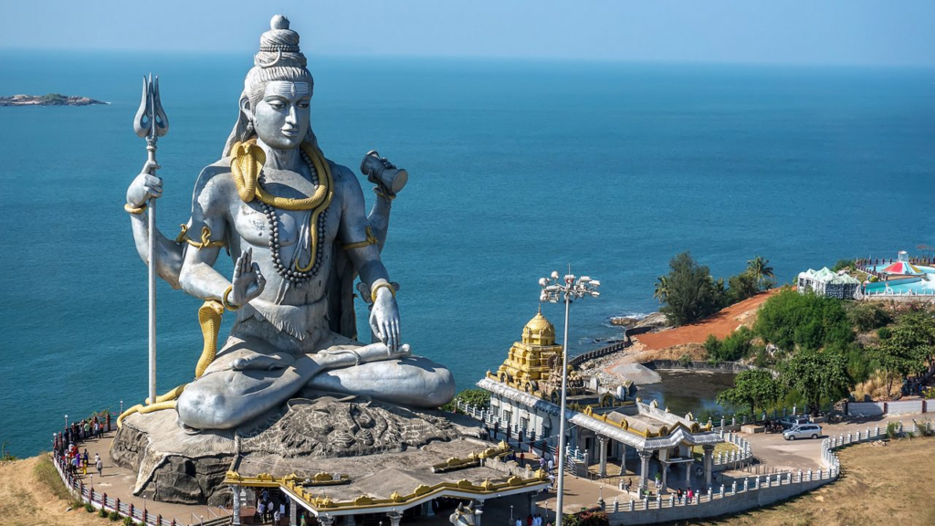10 Hidden Gems in India Every Traveler Must Visit once Massive Lord Shiva statue overlooking the Arabian Sea at Murudeshwar Temple, Karnataka, with coastal views and temple complex below